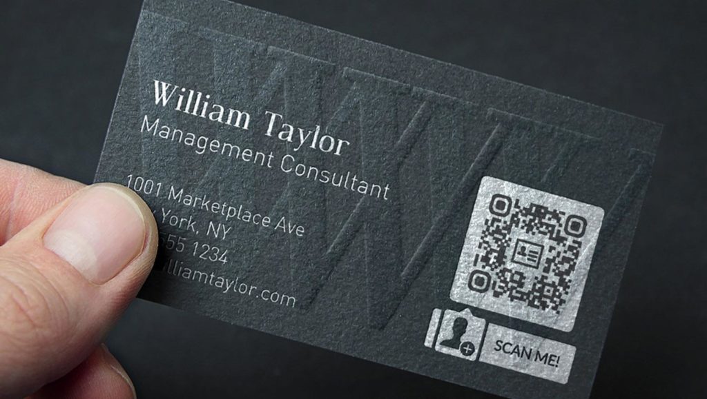 a matte black business card with a silver qr code