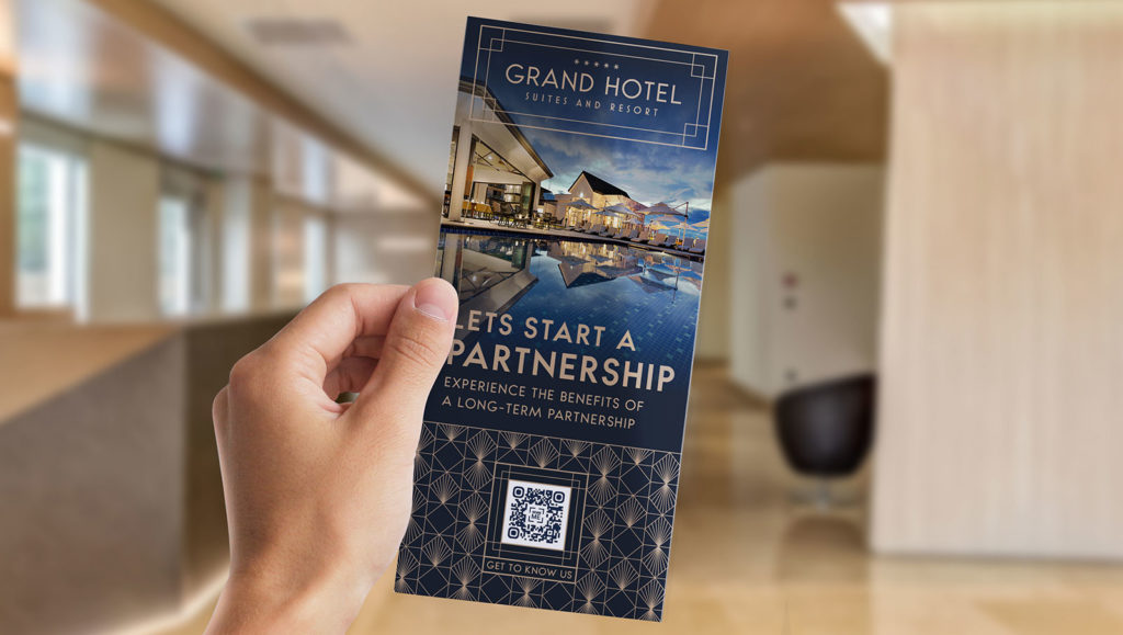 a luxury hotel brochure with a QR code in someone's hand